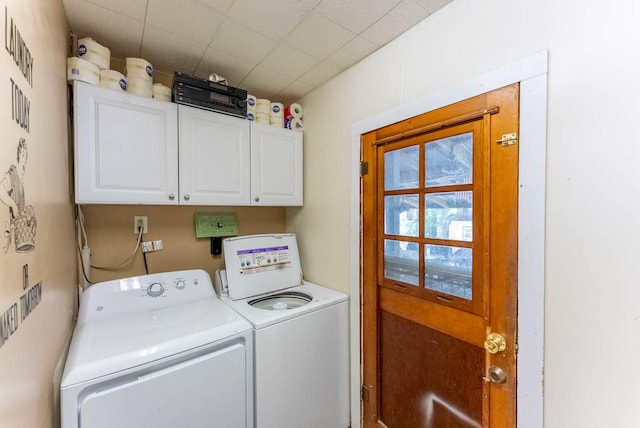 laundry room with independent washer and dryer and cabinets