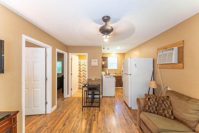 living room with light wood-type flooring and ceiling fan