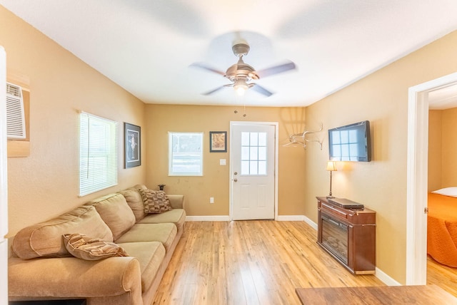 living room with ceiling fan and light hardwood / wood-style floors