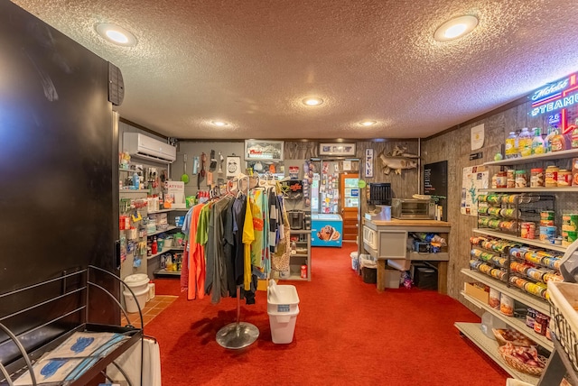 misc room featuring carpet flooring, a wall mounted AC, and a textured ceiling