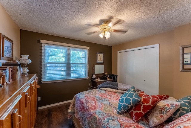 bedroom featuring a textured ceiling, ceiling fan, a closet, and dark hardwood / wood-style flooring