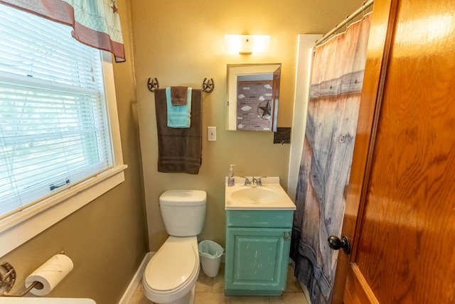 bathroom with tile patterned flooring, vanity, and toilet