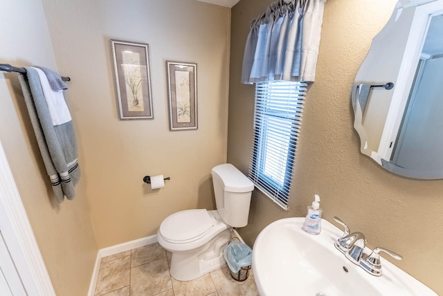 bathroom with sink, tile patterned flooring, and toilet