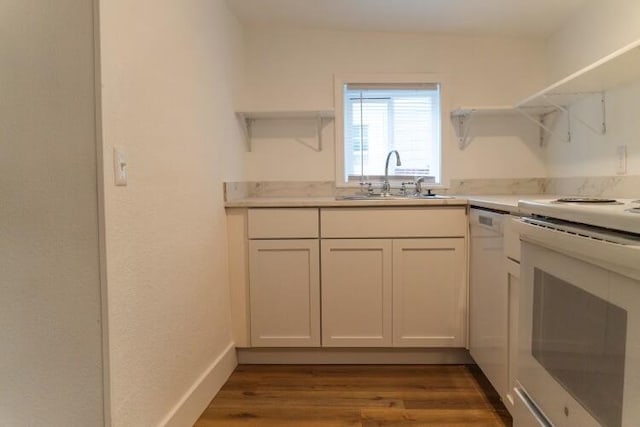 kitchen with hardwood / wood-style flooring, white appliances, sink, and white cabinets