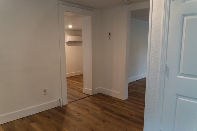 interior space with an AC wall unit and dark hardwood / wood-style flooring