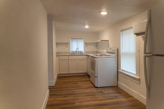 kitchen featuring dark wood-type flooring, white appliances, white cabinets, and sink