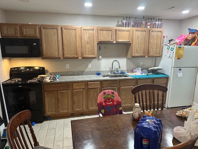 kitchen featuring sink and black appliances