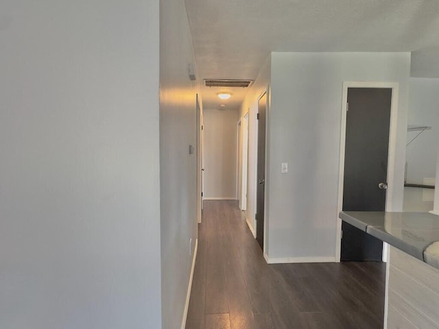 hallway with dark hardwood / wood-style floors