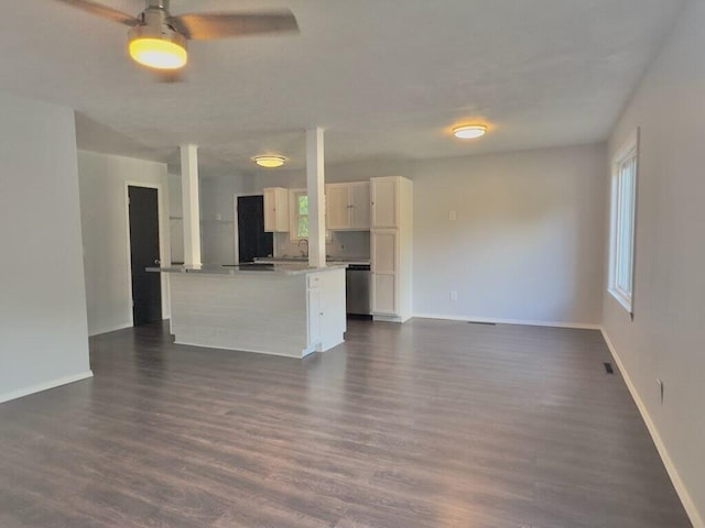 unfurnished living room featuring ceiling fan and dark hardwood / wood-style flooring