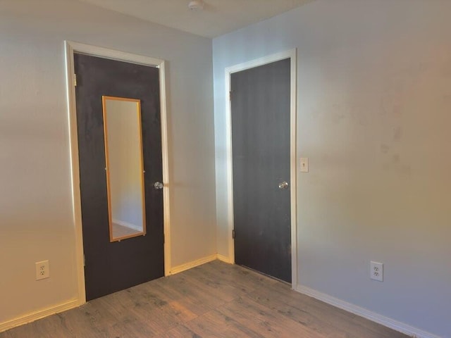 spare room with dark hardwood / wood-style flooring