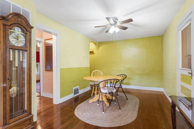 dining area with ceiling fan and dark hardwood / wood-style floors