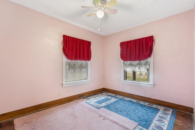 empty room with ceiling fan and hardwood / wood-style floors