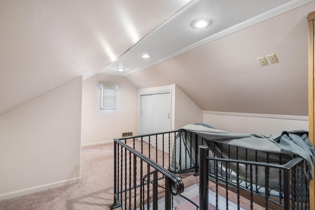 bonus room with vaulted ceiling and carpet