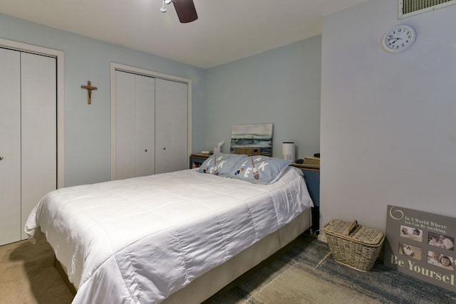 22016 Waters Edge Dr, Shell Knob, MO 65747 - carpeted bedroom featuring two closets, visible vents, and ceiling fan