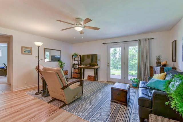 living room with light hardwood / wood-style floors and ceiling fan