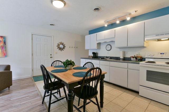 kitchen with sink, light wood-type flooring, white electric stove, white cabinetry, and range hood