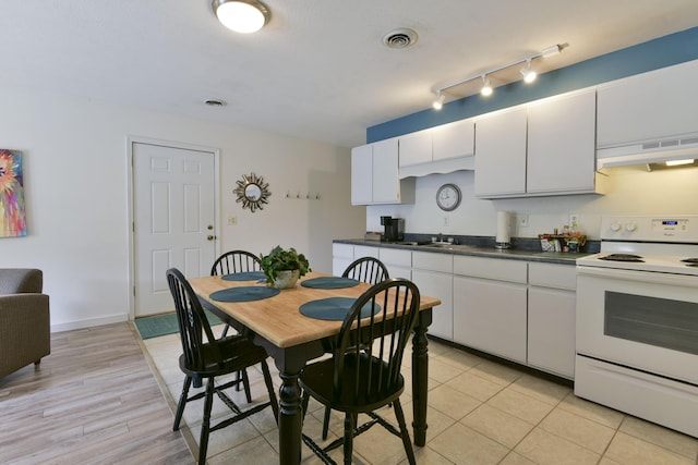 22016 Waters Edge Dr, Shell Knob, MO 65747 - kitchen with electric range, under cabinet range hood, a sink, and visible vents