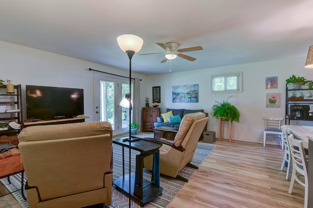 living room with light wood-type flooring and ceiling fan