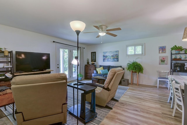 22016 Waters Edge Dr, Shell Knob, MO 65747 - living area featuring ceiling fan, baseboards, and light wood-type flooring