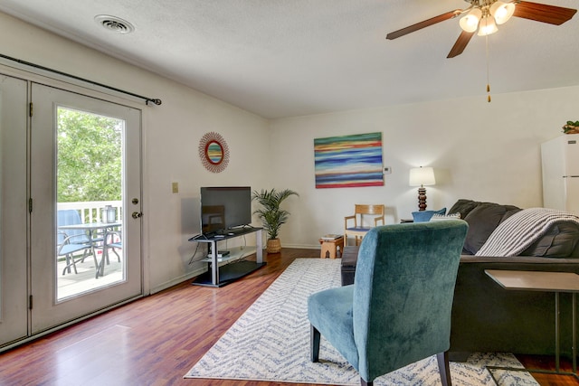 22016 Waters Edge Dr, Shell Knob, MO 65747 - living area with baseboards, wood finished floors, visible vents, and a ceiling fan