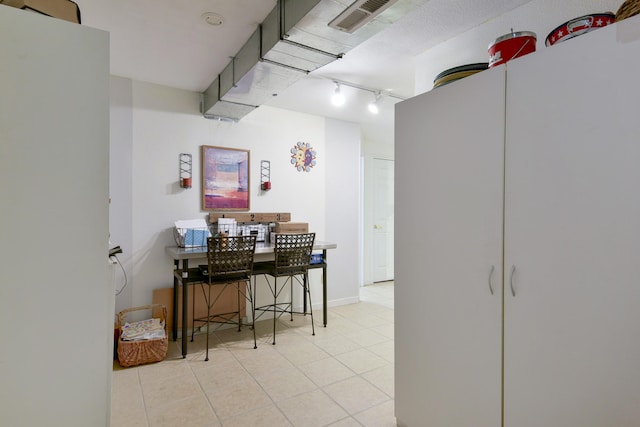 22016 Waters Edge Dr, Shell Knob, MO 65747 - interior space with visible vents, tile patterned flooring, and rail lighting