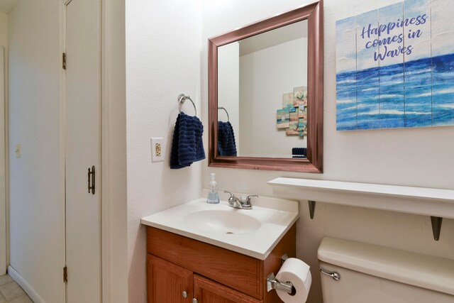 bathroom featuring toilet and vanity