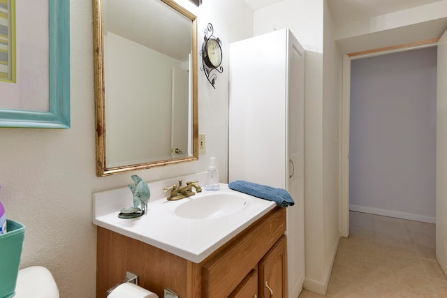 bathroom with vanity, toilet, and tile patterned flooring