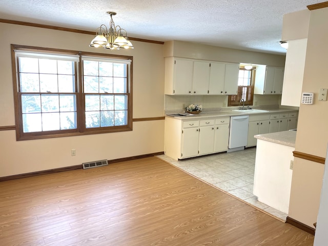 kitchen with white cabinetry, white dishwasher, decorative light fixtures, and an inviting chandelier