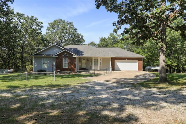 ranch-style house with covered porch, a garage, and a front yard