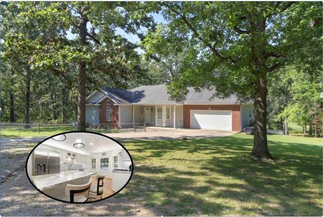 ranch-style home featuring a garage and a front lawn