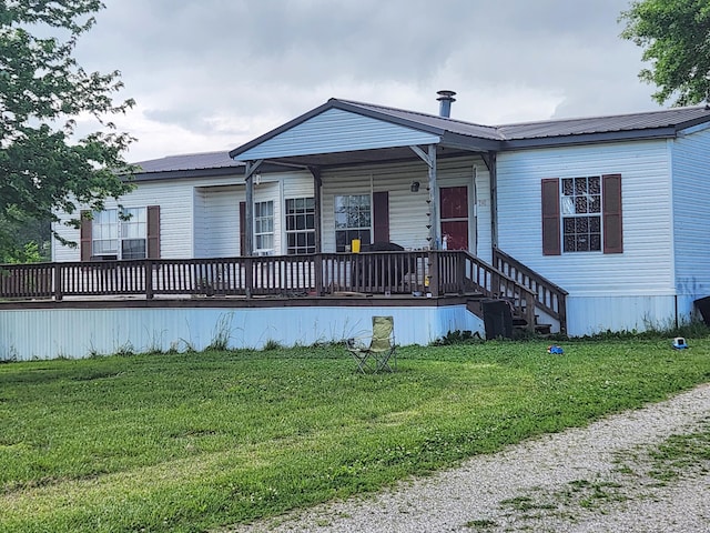 manufactured / mobile home featuring a front yard and a deck