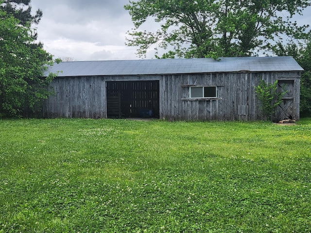 view of outbuilding featuring a lawn