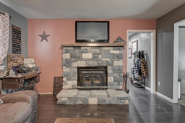 living room featuring dark wood-type flooring and a textured ceiling