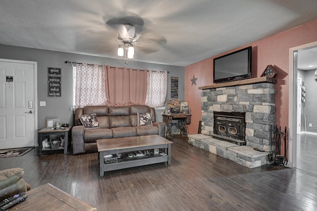 living room with ceiling fan, dark hardwood / wood-style floors, and a textured ceiling