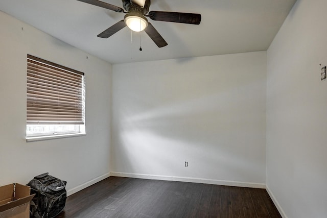 unfurnished room featuring baseboards, ceiling fan, and dark wood finished floors