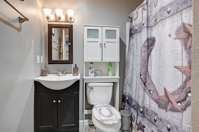 bathroom featuring vanity, toilet, and a shower with shower curtain