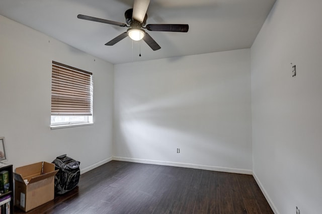 spare room with ceiling fan and dark wood-type flooring