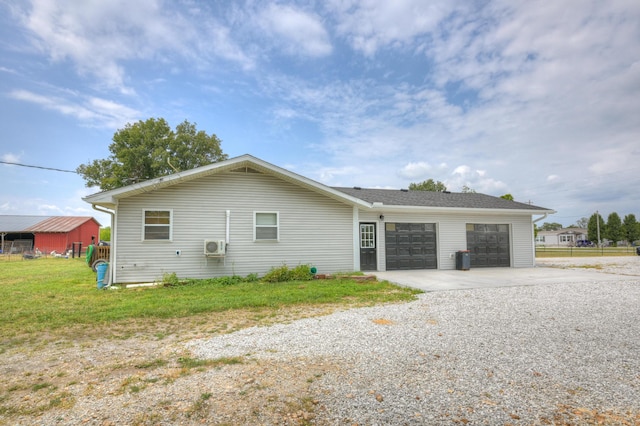 view of property exterior featuring a lawn, gravel driveway, and an attached garage