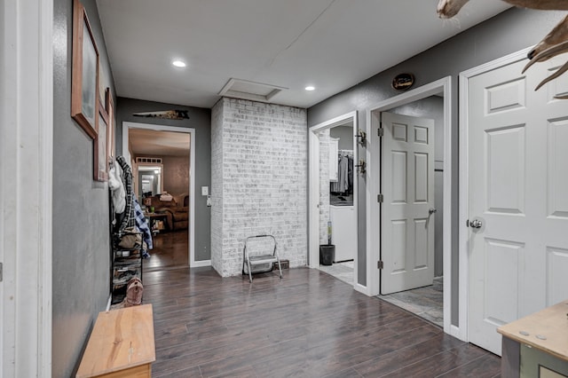 corridor with attic access, dark wood-type flooring, and recessed lighting