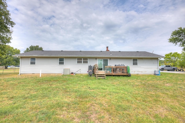 rear view of property featuring a yard and a wooden deck