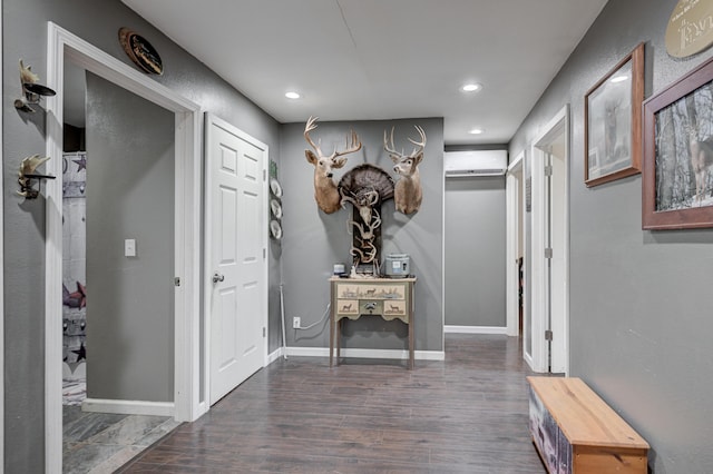 corridor with a wall mounted AC and dark hardwood / wood-style floors