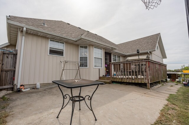 back of house featuring a patio area and a wooden deck