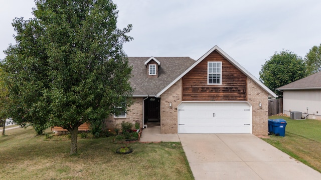 view of front of home featuring a front yard, a garage, and central AC unit