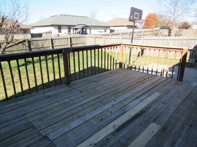 wooden deck featuring a yard