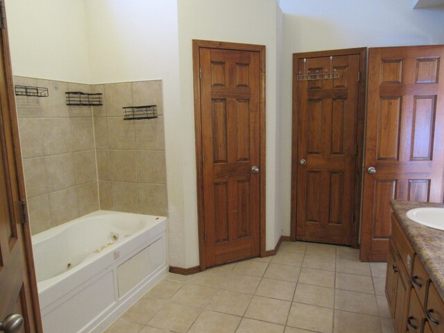 bathroom featuring a bathtub, vanity, and tile patterned flooring