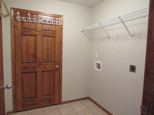 laundry area with electric dryer hookup, light tile patterned flooring, and hookup for a washing machine