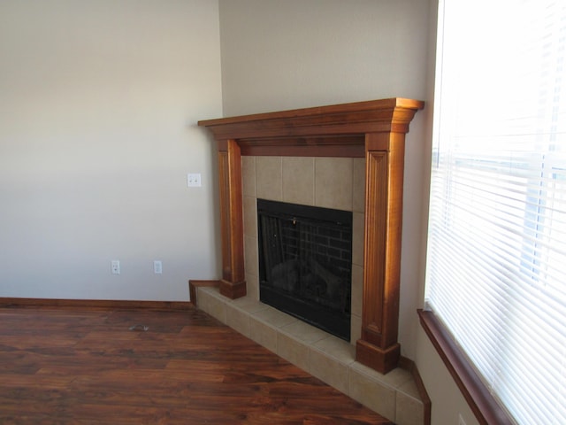 details with a tile fireplace and hardwood / wood-style flooring