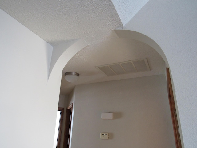 interior details featuring a textured ceiling