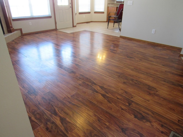 spare room featuring dark hardwood / wood-style flooring and a wealth of natural light