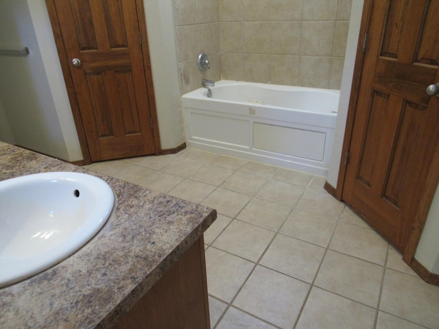 bathroom featuring tile patterned floors, a bathtub, and vanity